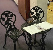 Place your sign in book on a pretty wrought iron table and chairs.